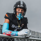 Youth Tackle Football Athlete Wearing  Showtime Kool-Aid Tropical Punch Compression Arm Sleeve and Tropical Punch Flavor Max AirFlow Lip Guard