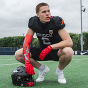 Youth Tackle Football Athlete Wearing Shock Doctor Showtime Kool-Aid Cherry Red Compression Arm Sleeve and Kool-Aid Cherry Flavor Gel Max Power Mouthguard
