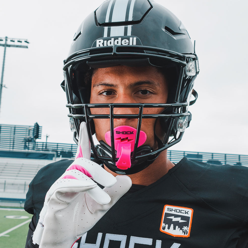 Youth Tackle Football Athlete Wearing Shock Doctor Pink Bolt Lip Guard