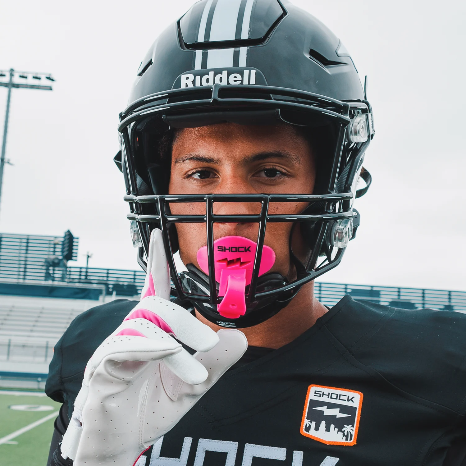 Youth Tackle Football Athlete Wearing Shock Doctor Pink Bolt Lip Guard