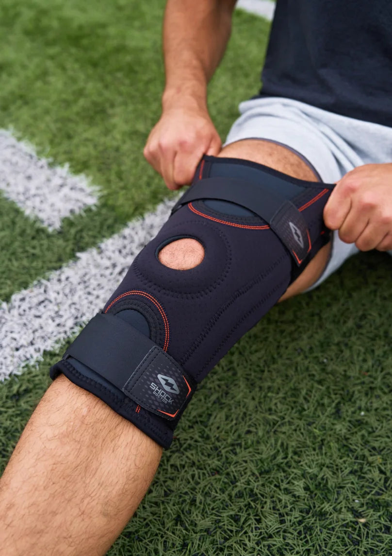 Athlete Sliding on Shock Doctor Brace Over Knee