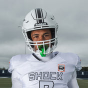 Football player in white Shock Doctor uniform and helmet wearing a chrome slime green Shock Doctor Max AirFlow Lip Guard on the field