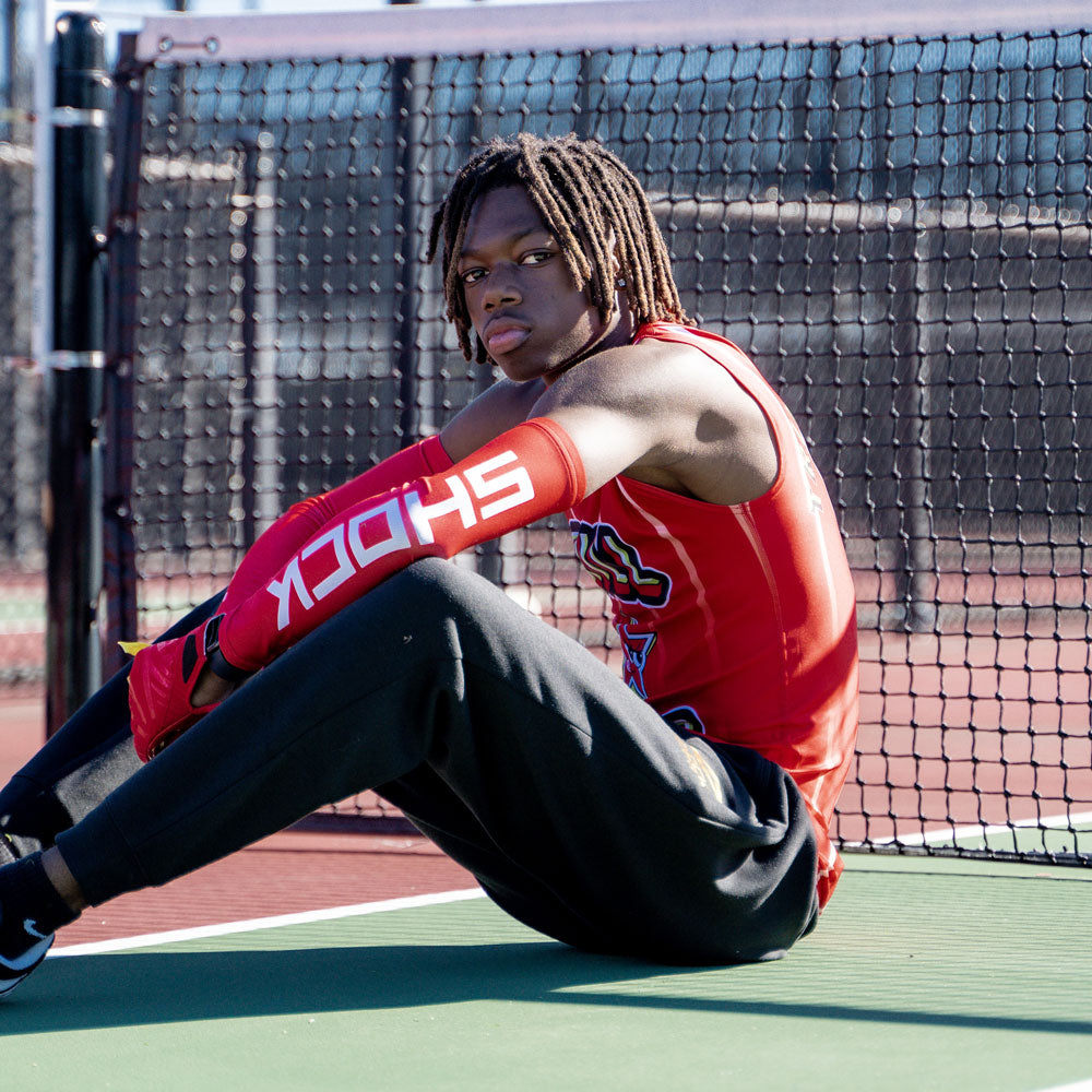 Lifestyle Image of Youth 7v7 Football Athlete Wearing Shock Doctor Red Compression Sleeves