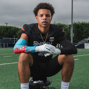 Youth Tackle Football Athlete Wearing  Showtime Kool-Aid Tropical Punch Compression Arm Sleeve and Tropical Punch Flavor Gel Max Lip Guard