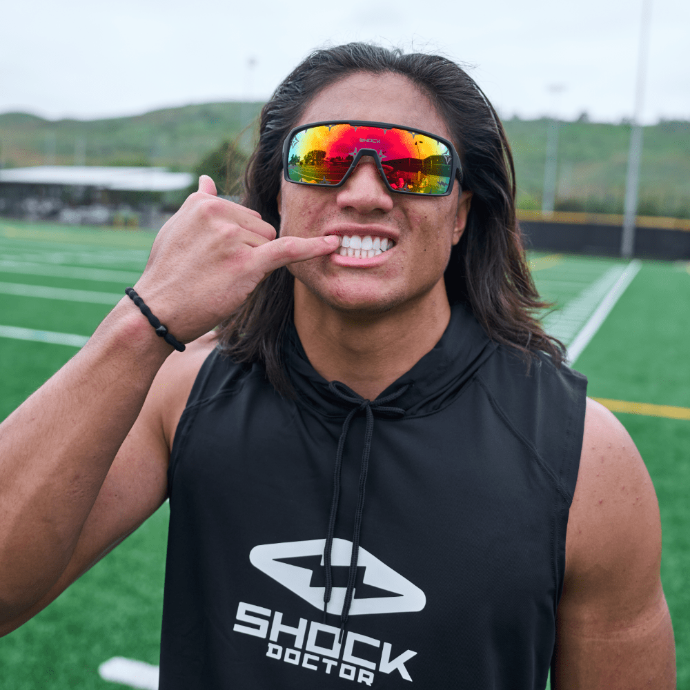 Youth Football Player Wearing Shock Doctor Performance Sleeveless Hoodie in Black