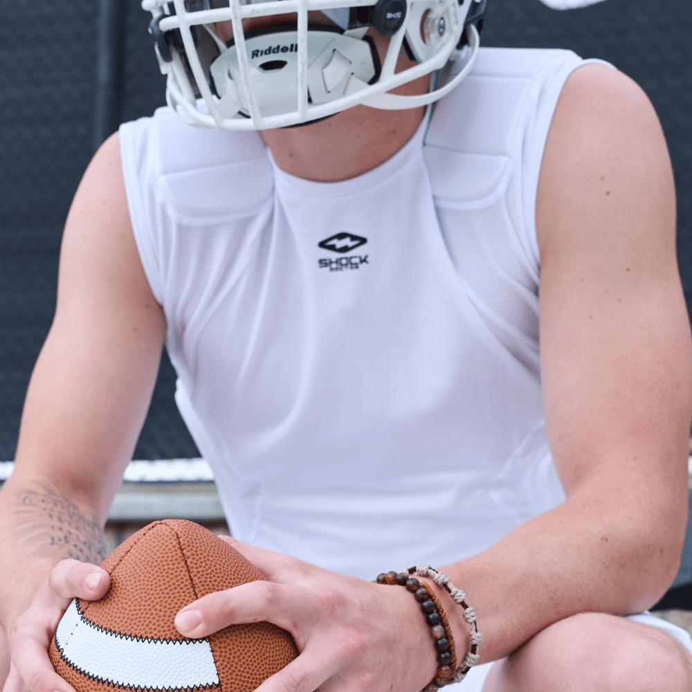 Youth Tackle Football Athlete Wearing Shock Doctor Showtime 5-Pad  White Top While Holding Football