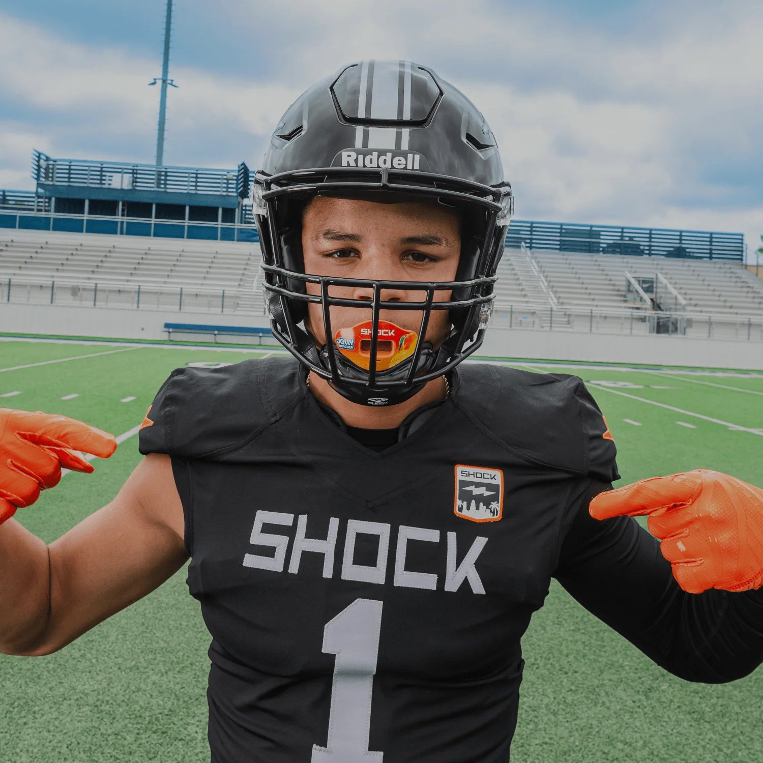 Link to Shock Doctor New Arrivals Collection - Image Features Youth Tackle Football Athlete Wearing Jolly Rancher Max AirFlow Football Lip Guard (Mango Flavor)