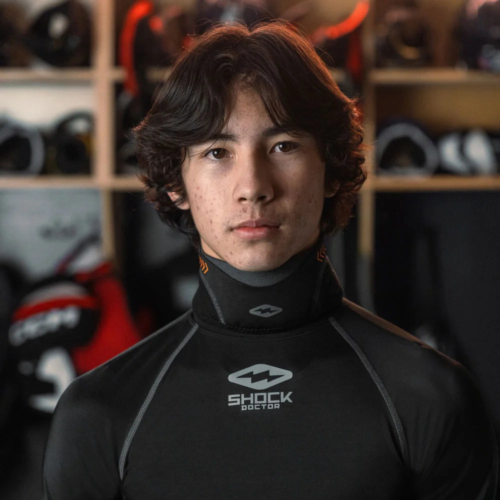 Youth Hockey Player Wearing Shock Doctor Protective Neck Guard with Hockey Compression Shirt