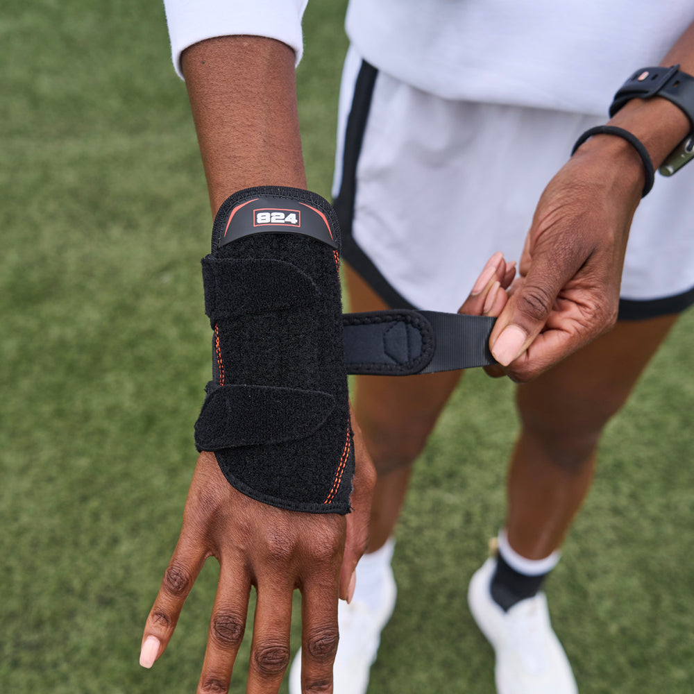 Athlete Strapping On Shock Doctor Wrist 3-Strap Support