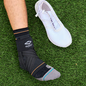 Shock Doctor Ultra Knit Ankle Brace with Figure 6 Strap & Stays - On Model - Side View of Ankle Brace on Grass Field