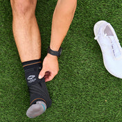 Shock Doctor Ultra Knit Ankle Brace with Figure 6 Strap & Stays - On Model - Front View of Ankle Brace on Grass Field