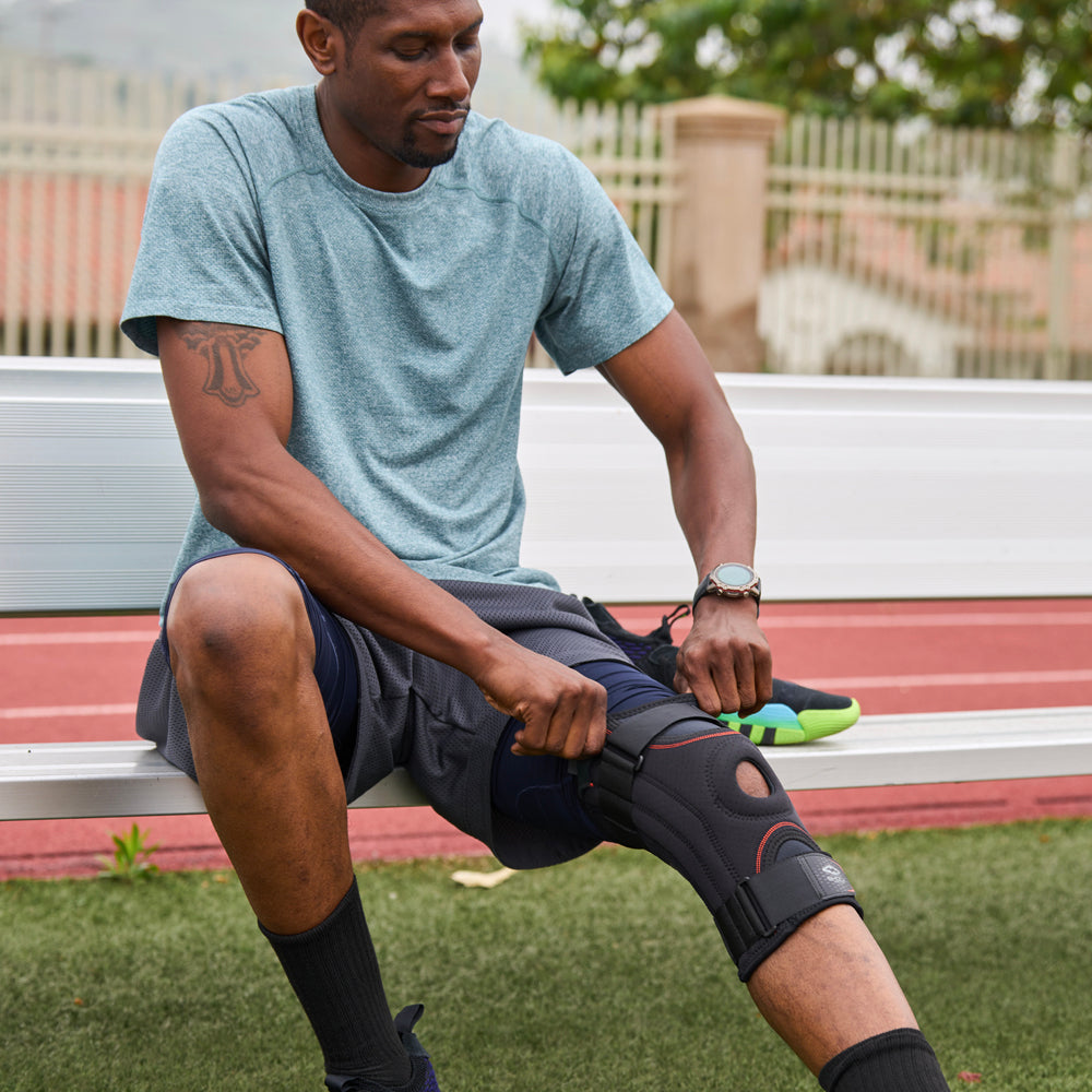 Athlete Adjusting the Shock Doctor Knee Stabilizer with Flexible Support Stays for a Better Fit