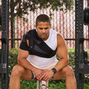 Athlete Wearing Shock Doctor Ultra Shoulder Support with Stability Control  - Sitting on Weight Bench