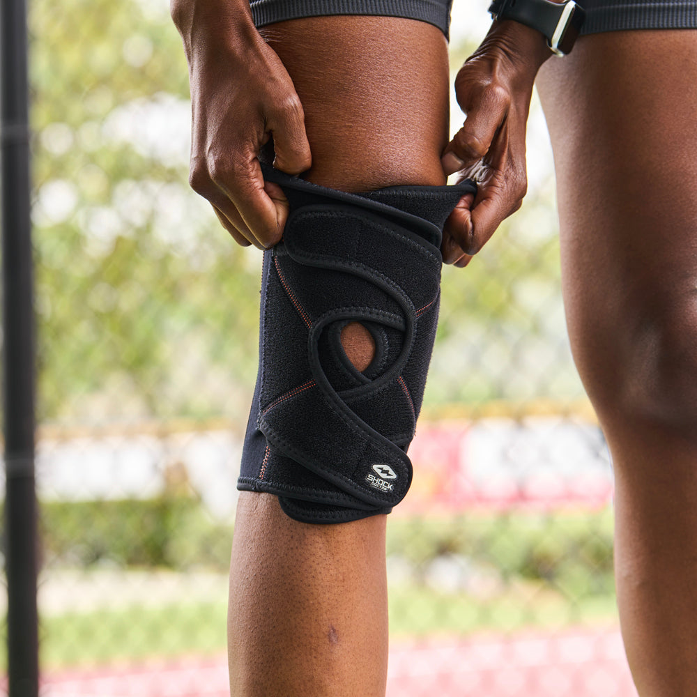 Detail View of Athlete Slipping on Shock Doctor Quick-On™ Knee Support with Versatile Over Wrap System™