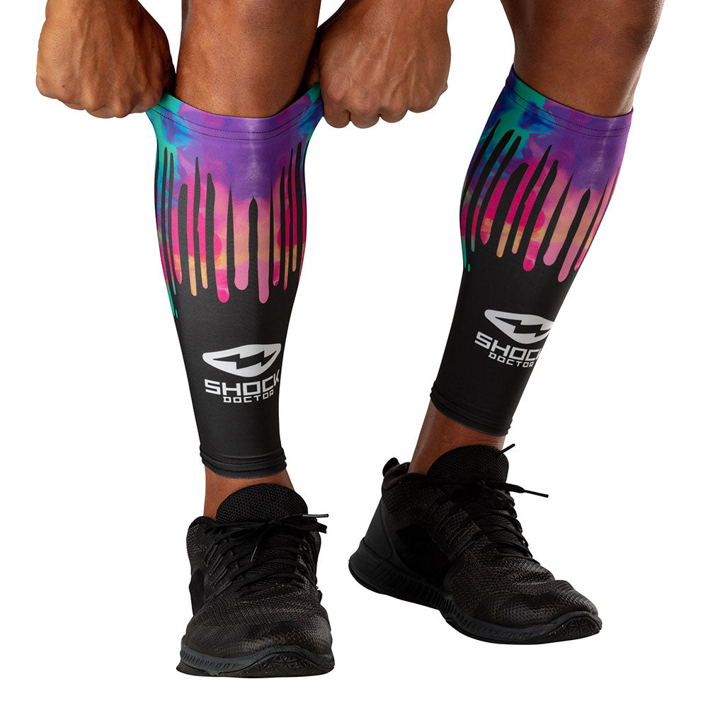 Shock Doctor Black Tie Dye Drip Showtime Compression Calf Sleeves - Model Pulling Sleeve Over Calf/Shin