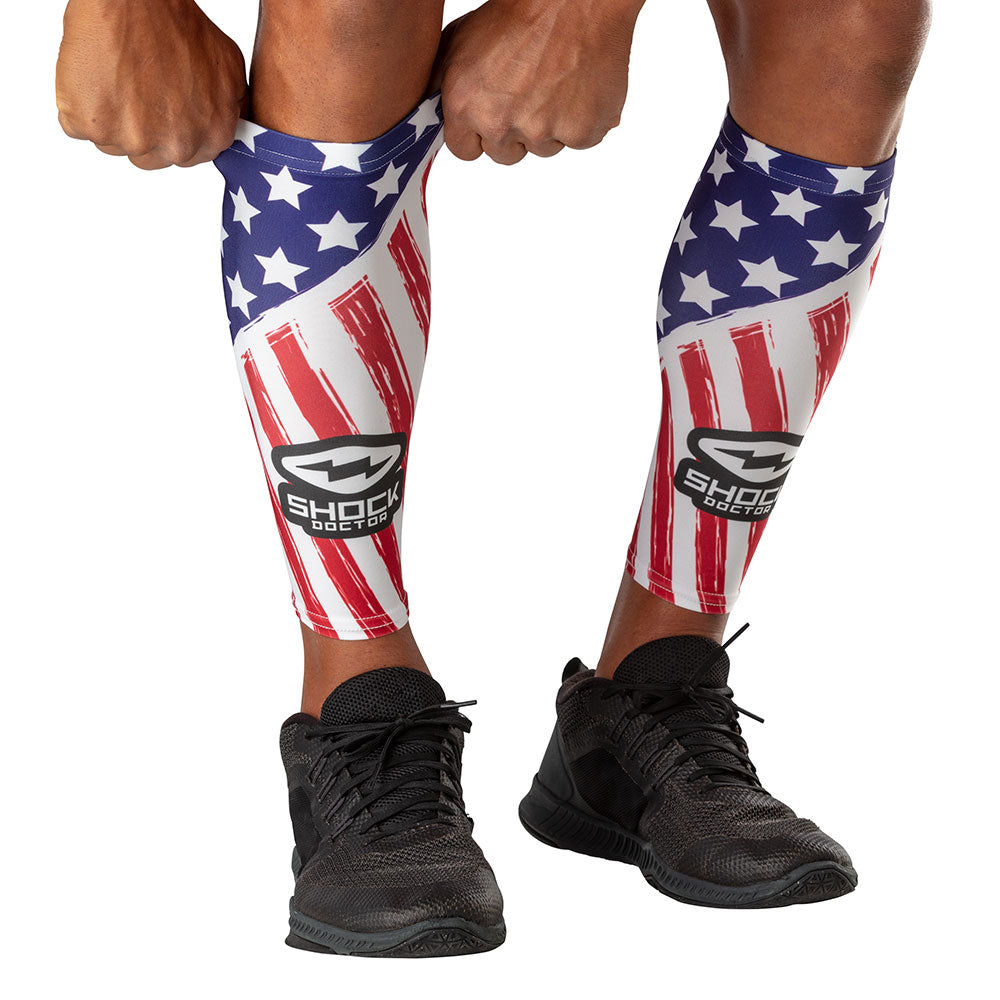 Shock Doctor Stars & Stripes Showtime Compression Calf Sleeves - Model Pulling Sleeve Over Calf/Shin