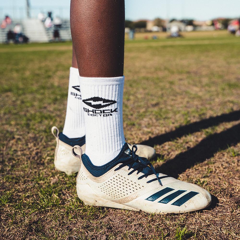 Lifestyle Image of Athlete Wearing Shock Doctor White Athletic Socks