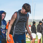 Youth Football Player Wearing Performance Grey Sleeveless Athletic Hoodie by Shock Doctor, designed for sports and training. Features soft, flexible fabric for comfort and fast drying.