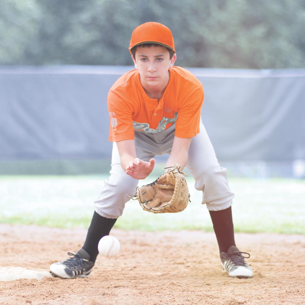 Youth Baseball Athlete Wearing Shock Doctor American Flag Core Compression Short with Bio-Flex Cup - Attempting to Catch Baseball