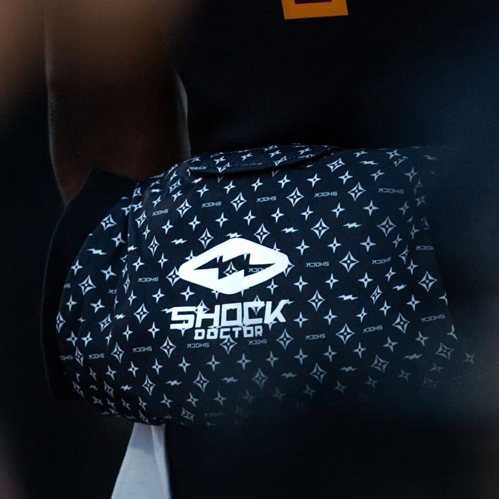Lifestyle Image of Shock Doctor Showtime Football Hand Warmer - Black/White Lux Color - On Football Player