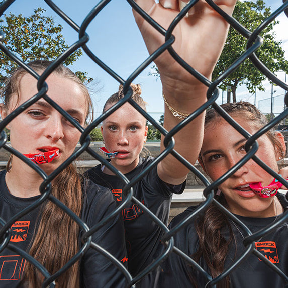 3 Youth Female Athletes Wearing Shock Doctor Gel Max Mouthguards