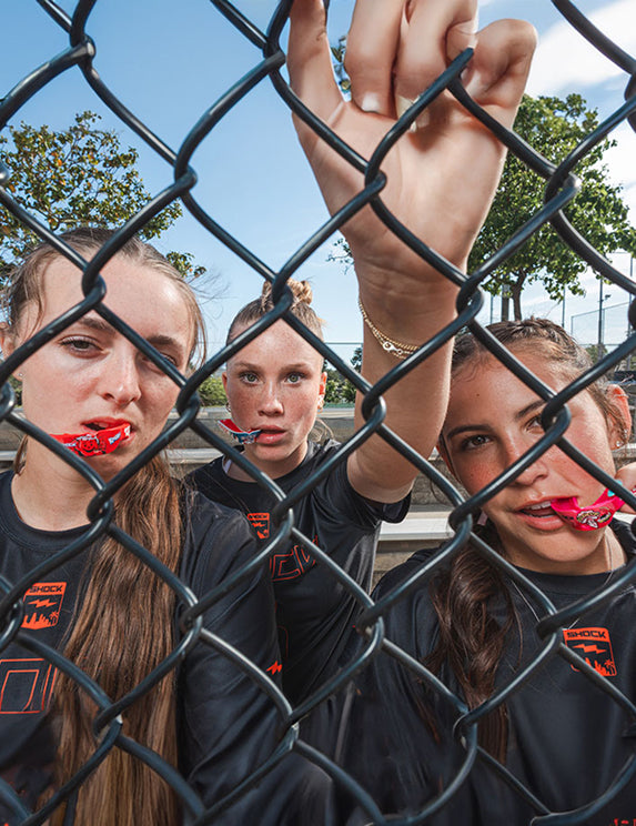 3 Youth Female Athletes Wearing Shock Doctor Gel Max Mouthguards