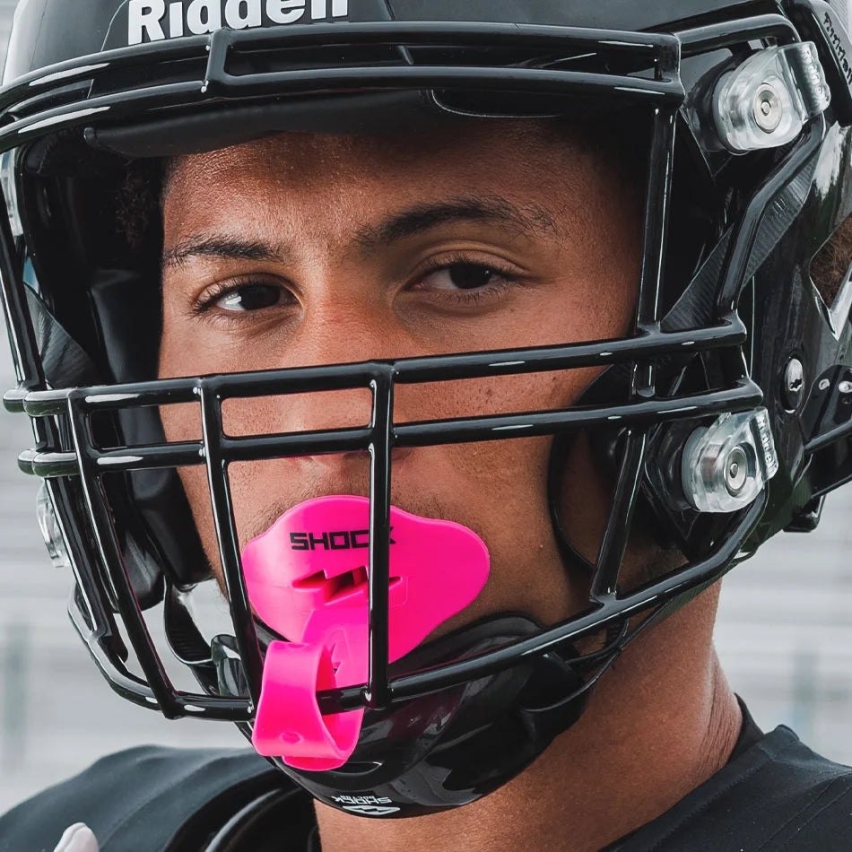 Link to Bolt Lip Guards Collection (Model Wearing Pink Bolt Lip Guard in with Football Helmet On)