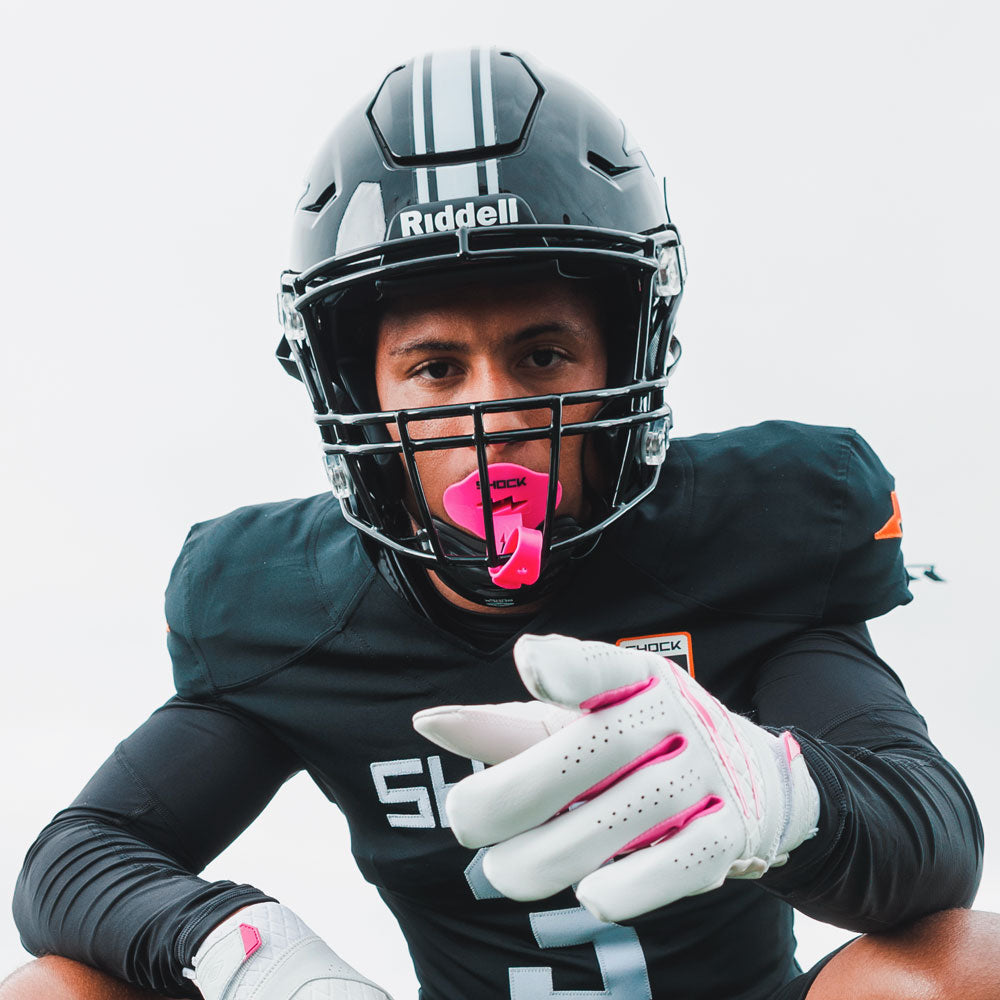 Youth Tackle Football Athlete Wearing Shock Doctor Pink Bolt Lip Guard