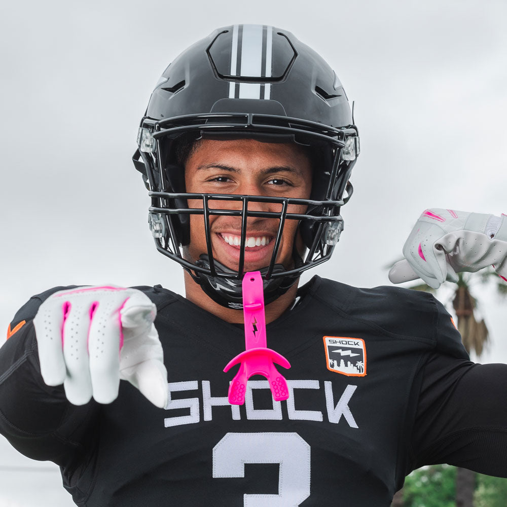 Youth Tackle Football Athlete Wearing Shock Doctor Pink Bolt Lip Guard