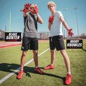 Football recruits Blake Gunter and Brody Knowles on a field wearing Kool-Aid Cherry cleats and gloves by Phenom Elite