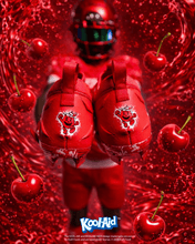 Player holding Kool-Aid Cherry cleats heel-first to show the Kool-Aid Man graphic, with cherries and red splash
