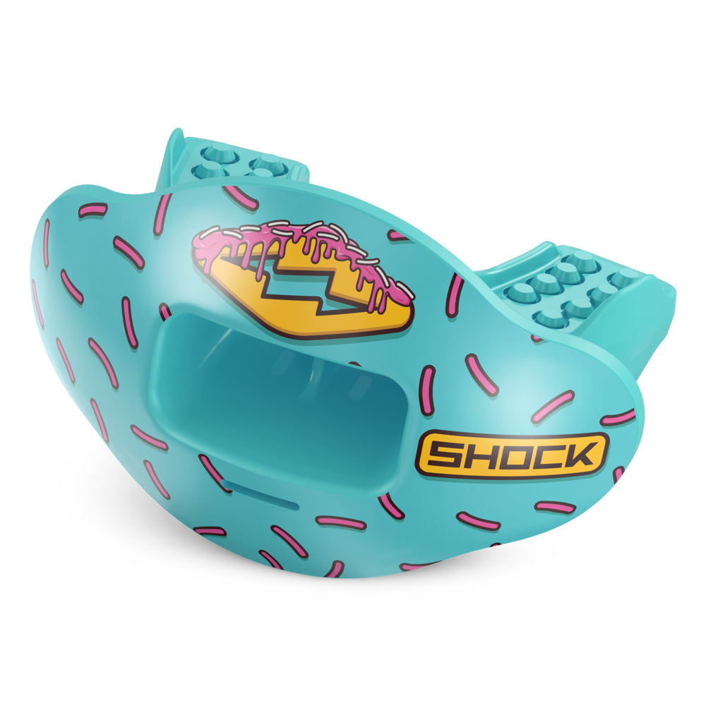 A turquoise blue protective mouthguard featuring a sprinkle pattern, a donut graphic with pink frosting, and a yellow 'SHOCK' logo, shown on a white background.