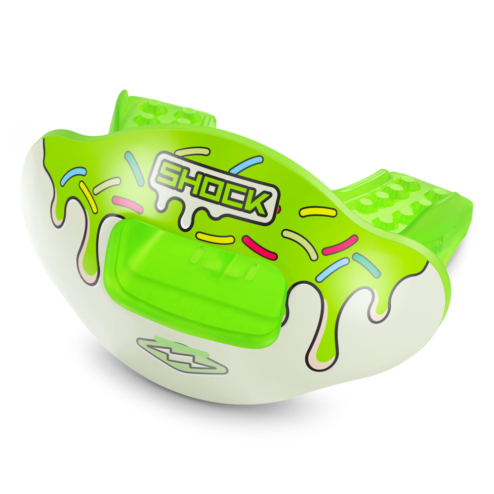 A bright lime green and white mouthguard with a dripping candy sauce design and colorful sprinkle accents, featuring the brand name 'SHOCK' on the front, set against a plain white background.