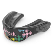 Shock Doctor Gel Max Power Print mouthguard in Divine Drip, shown at a three-quarter angle. Black mouthguard with multicolored gothic cross graphics in pink, blue, green, and yellow, "Shock" lettering in Old English script, and a honeycomb-pattern back channel with a center breathing hole.
