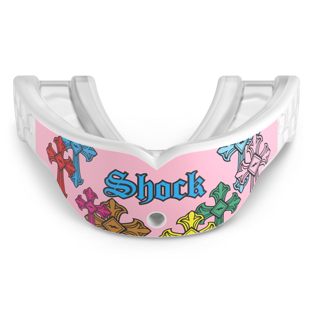 Front view of the Shock Doctor Gel Max Power Print mouthguard in Pink Divine Drip. Pink and white mouthguard featuring multicolored gothic crosses in red, blue, green, orange, and yellow wrapping the front, with "Shock" in blue Old English lettering and a center breathing hole.