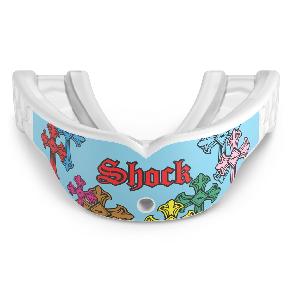 Front view of the Shock Doctor Gel Max Power Print mouthguard in Blue Divine Drip. Light blue and white mouthguard featuring multicolored gothic crosses in red, blue, pink, green, orange, and yellow wrapping the front, with "Shock" in red Old English lettering and a center breathing hole.