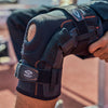 Lifestyle Image of Athlete Wearing Shock Doctor Ultra Knee Support with Bilateral Hinges  