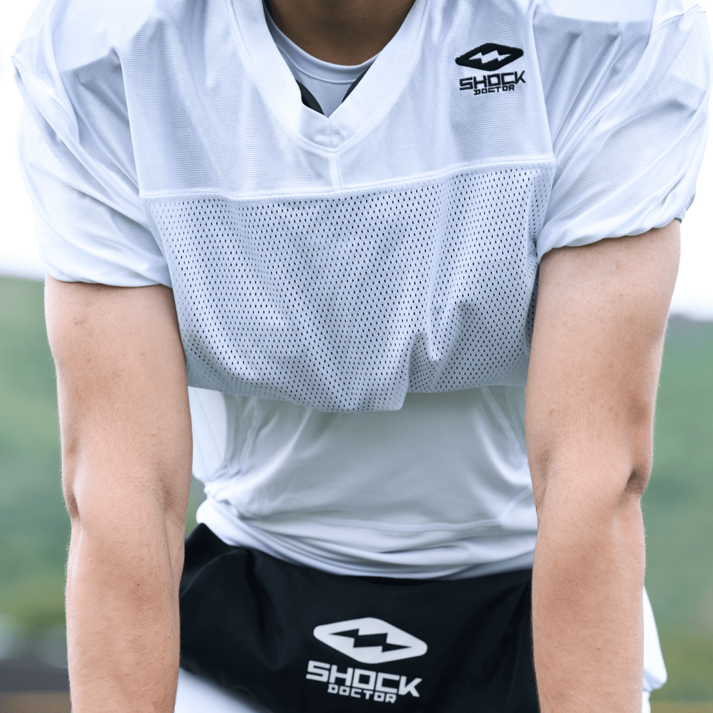 Detail View of Tackle Football Athlete Wearing Shock Doctor Showtime White Practice Jersey 