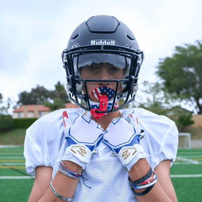 Shock Doctor Stars and Stripes/Gold Showtime Football Receiver Gloves - Lifestyle Shot on Youth Football Player Wearing Gloves