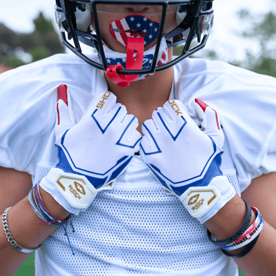 Shock Doctor Stars and Stripes/Gold Showtime Football Receiver Gloves - Lifestyle Detail Shot on Youth Football Player Wearing Gloves