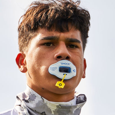 Youth Football Player Wearing Shock Doctor 3D Stitch Max AirFlow Football Mouthguard (White/Columbia Blue)