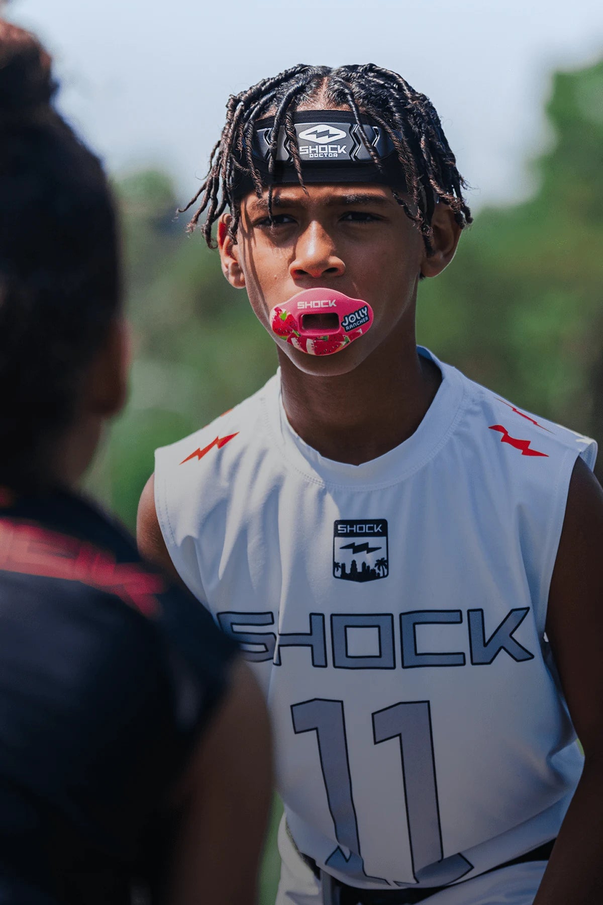 Two youth athletes wearing Showtime HEX Head Band and a  Lip Guard
