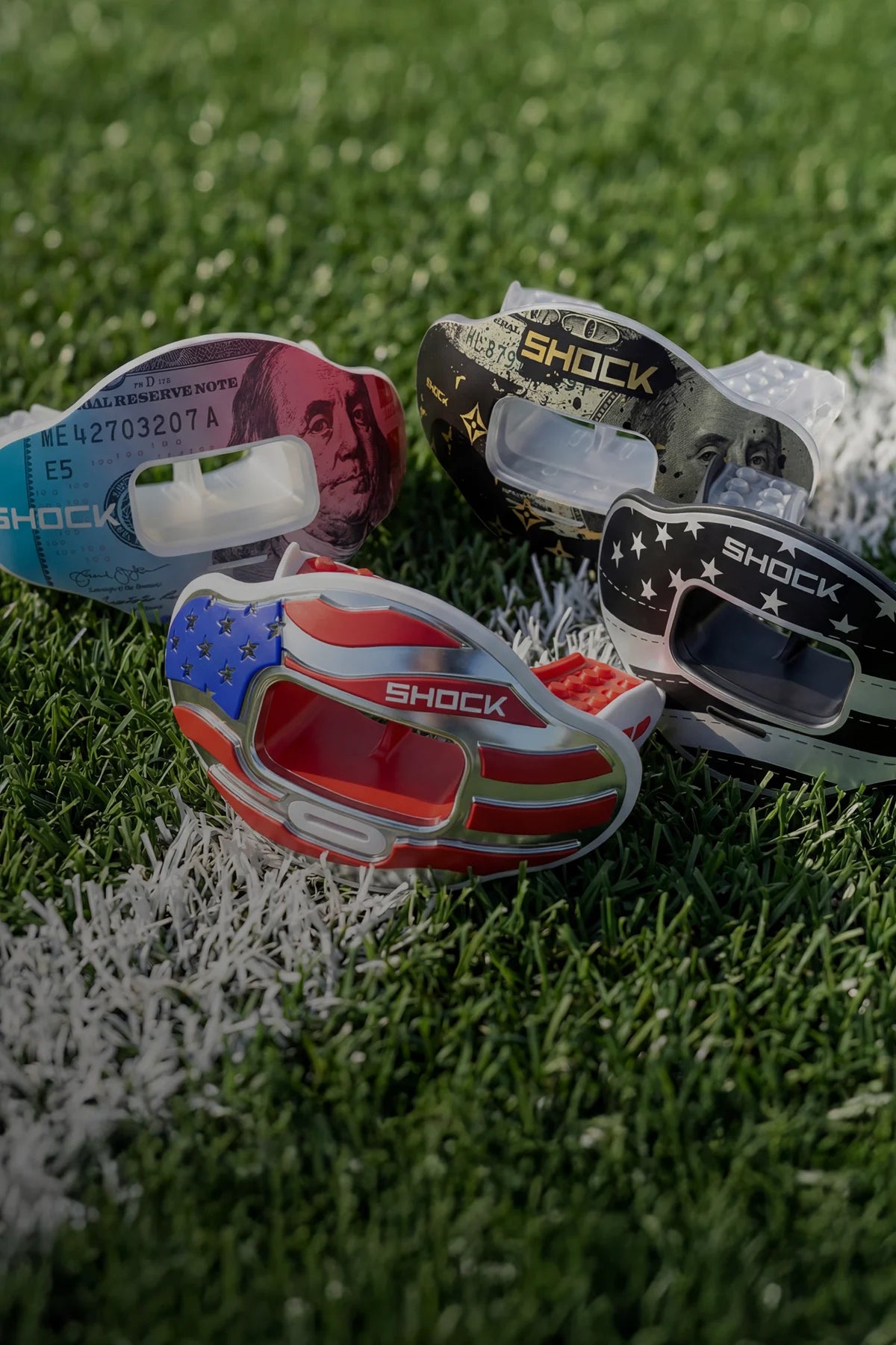 Colorful shock doctor mouthguards on a grass field