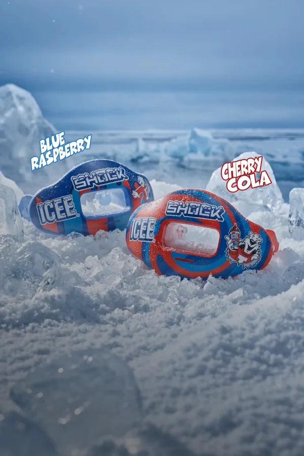 Two ICEE lip guards, one blue raspberry flavor and one cherry cola flavor, surrounded by ice cubes with a snowy background.