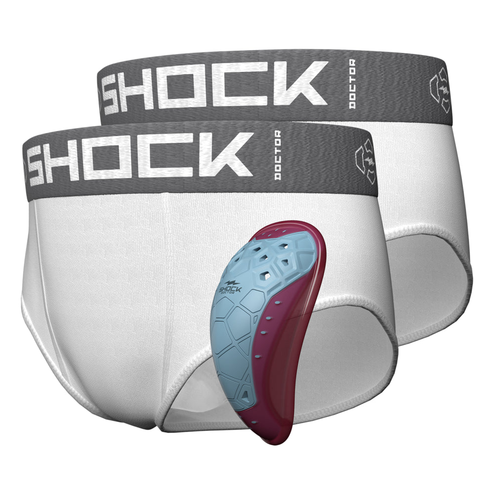 Shock Doctor Core 2-Pack Brief with BioFlex 2.0 Cup, two white youth briefs with gray waistbands shown alongside green and white protective cup
