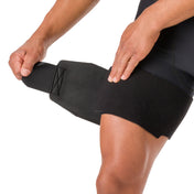 Close-up of hands adjusting the Shock Doctor Adjustable Groin Wrap's hook-and-loop closure for a custom fit