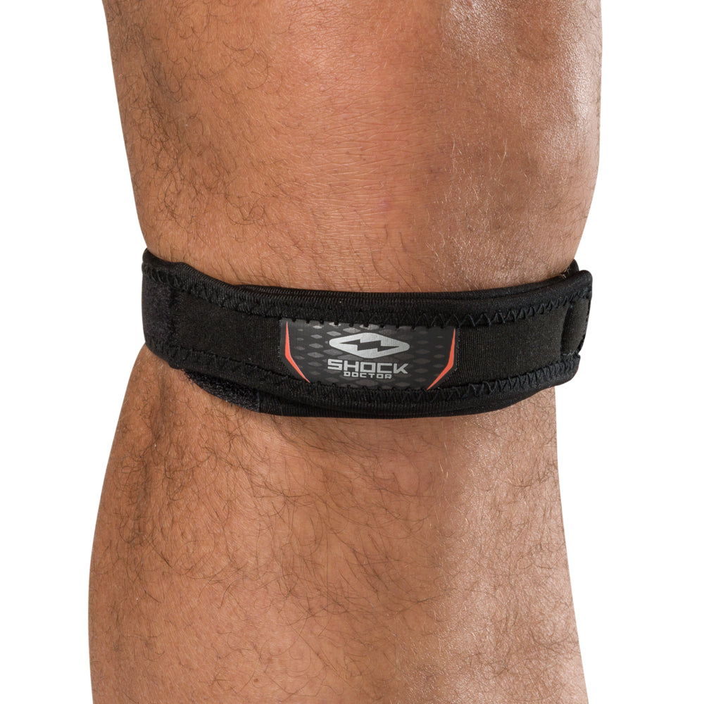 Shock Doctor Jumper Knee/Patella Support Strap in black worn on knee, front view showing logo