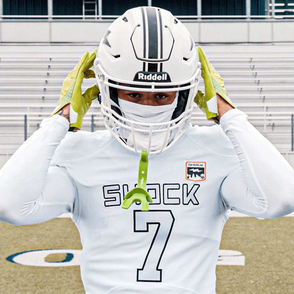 Person wearing a football uniform with 'Shock' and number '7' on a football field.