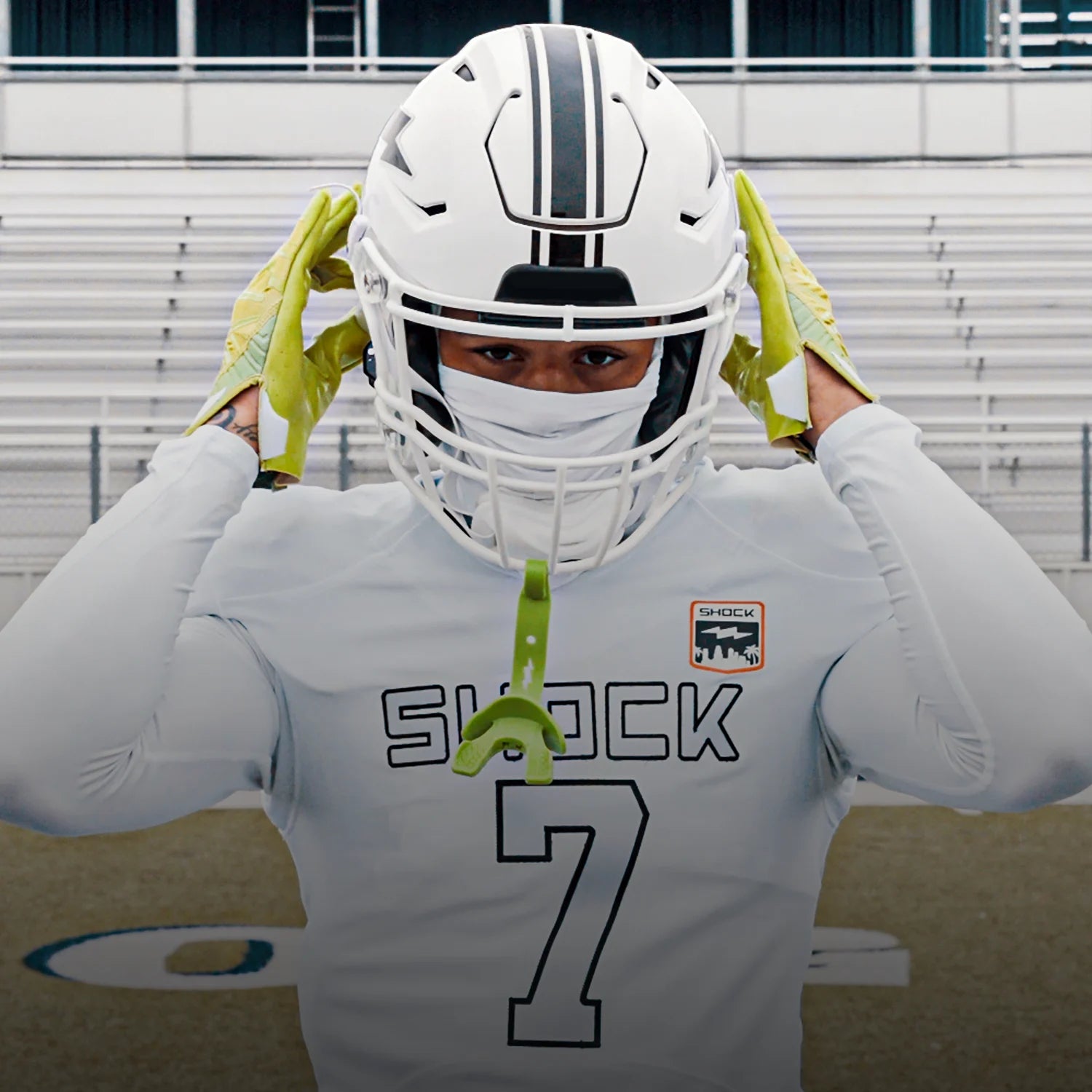 Person wearing a football helmet and uniform with 'Shock' and number '7' on a stadium background