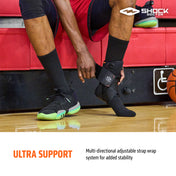 Basketball player applying Shock Doctor Ultra Gel Lace Ankle Support with Straps, featuring a multi-directional adjustable strap system for enhanced ankle stability and injury prevention. Ideal for sports like basketball and volleyball. Shock Doctor logo shown.